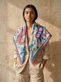 Maison OYO women's large 100% linen square scarf, Santiago design 100x160 cm, bold South American folk art patterns of horses, metalware, and plants in blue, terracotta, and yellow.