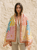 Maison OYO women's large 100% linen square scarf, Bloom design 100x160 cm, swirling floral patterns in pink, blue, yellow, and orange, orange border with black polka dots.