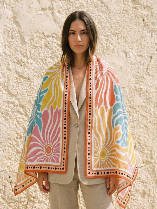 Maison OYO women's large 100% linen square scarf, Bloom design 100x160 cm, swirling floral patterns in pink, blue, yellow, and orange, orange border with black polka dots.